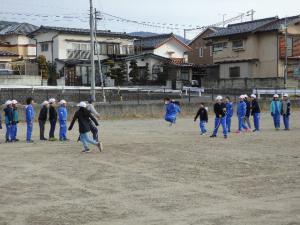 校庭で長縄とびをしている生徒たちの写真