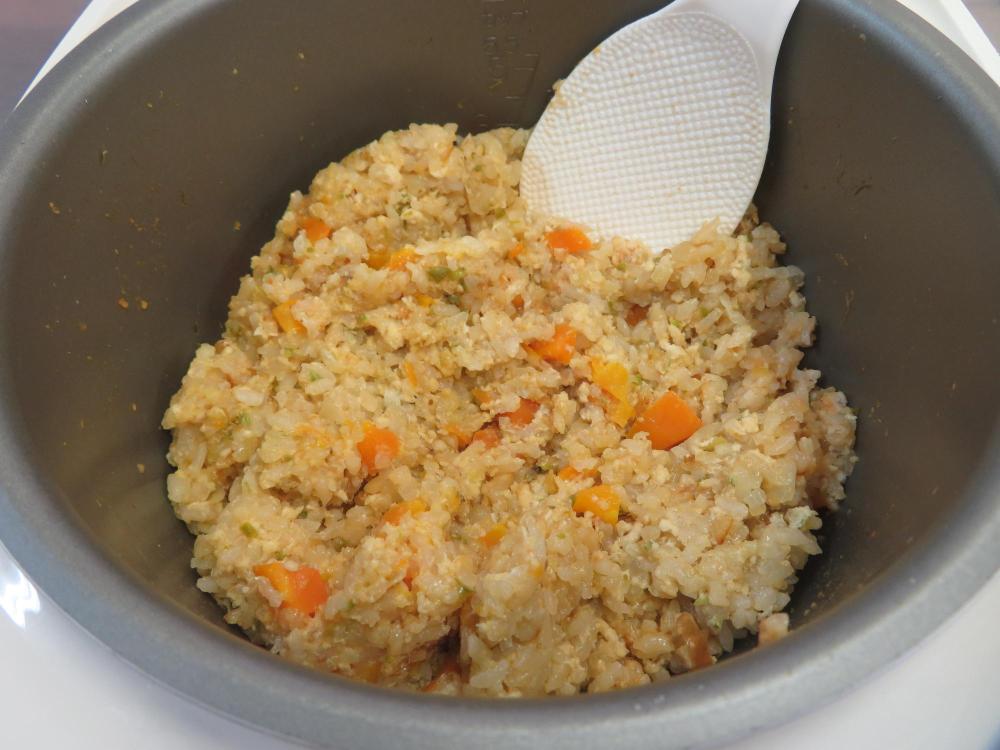 炊きあがったチキンライスを混ぜている写真