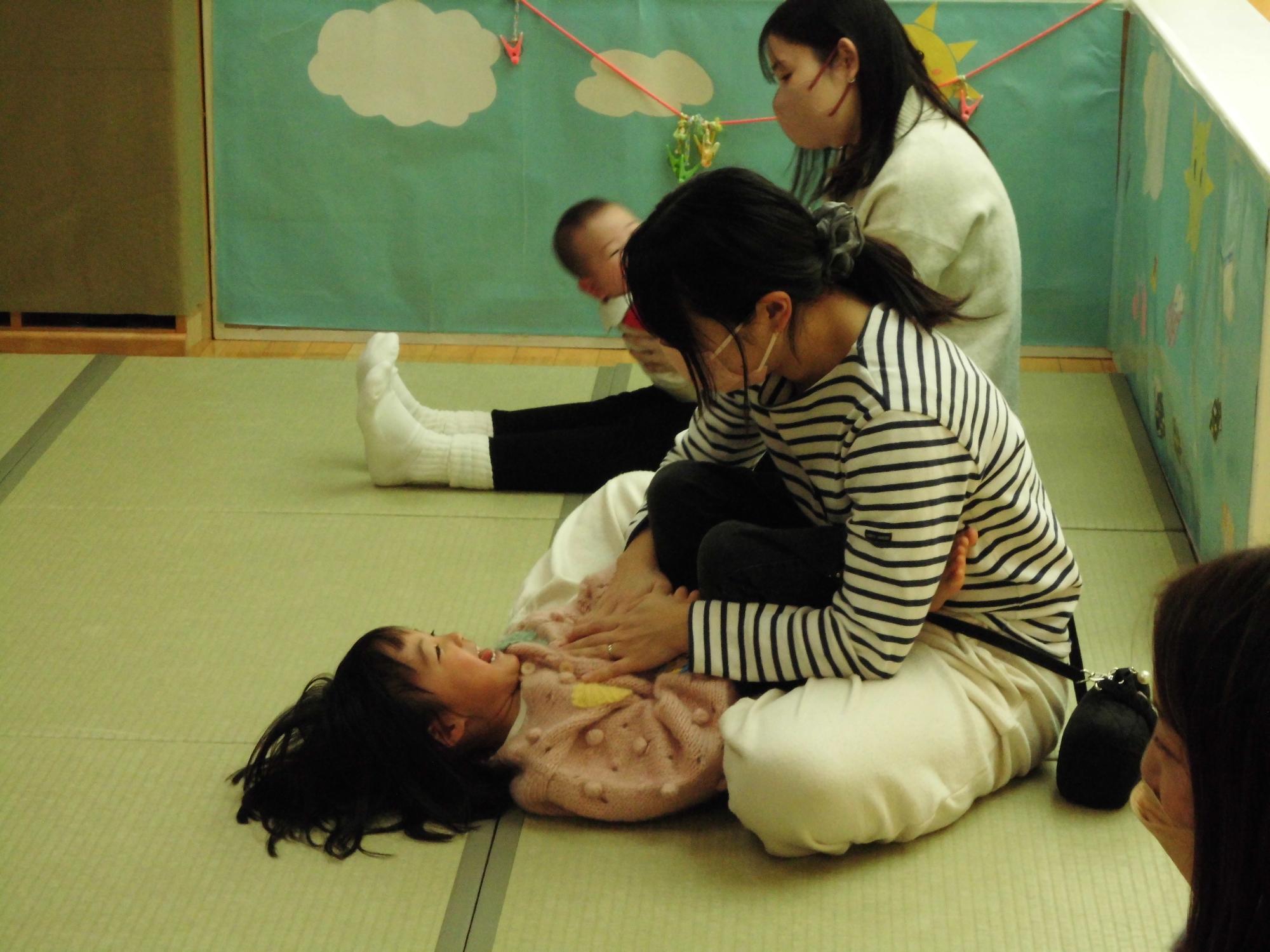 ふれあい遊びでじゃれあう親子