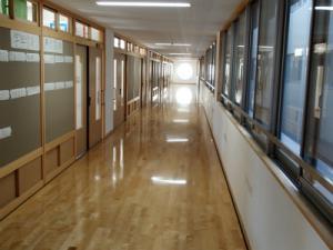 新しい校舎の廊下の床がピカピカしていて光が反射している写真